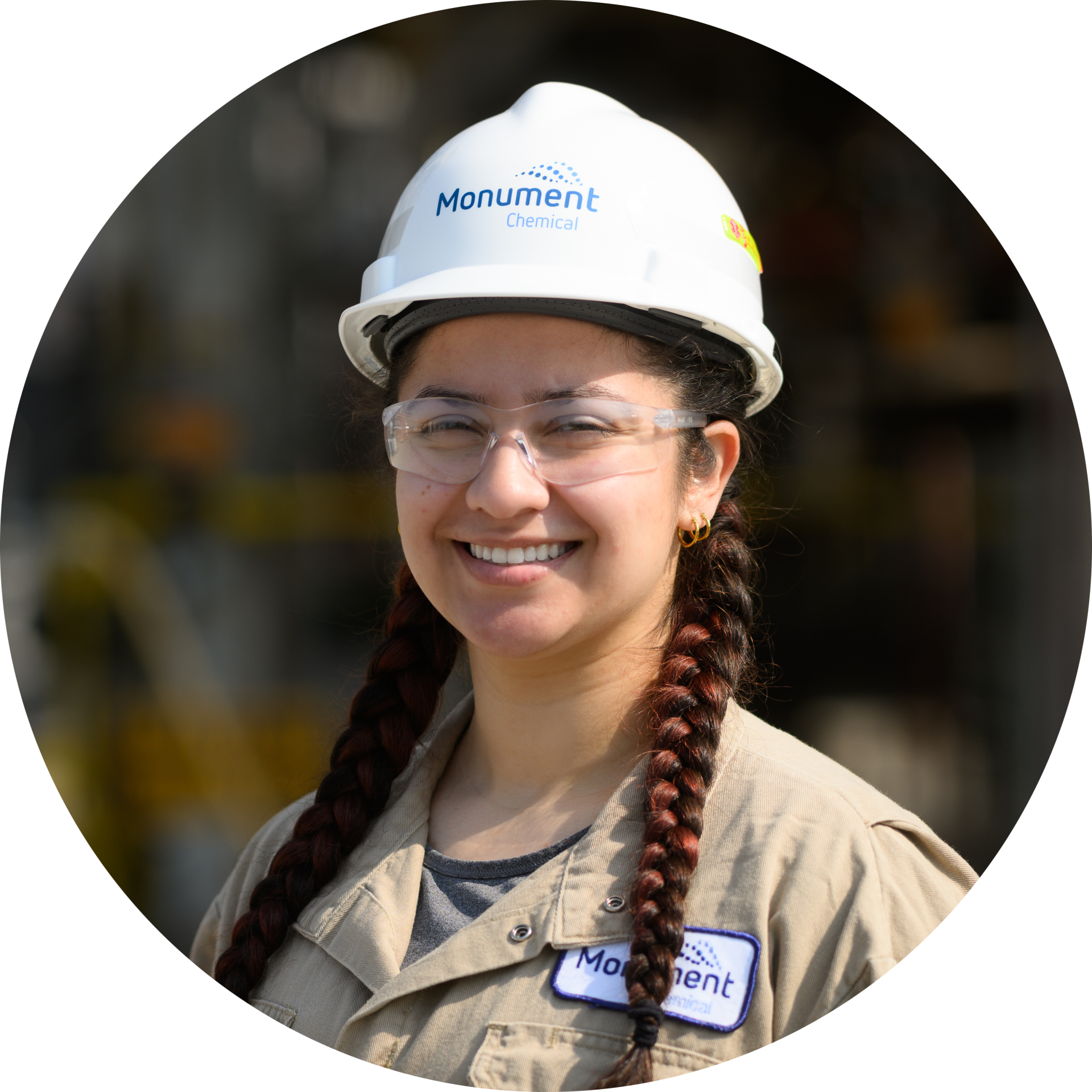female Monument Chemical employee wearing safety gear smiling